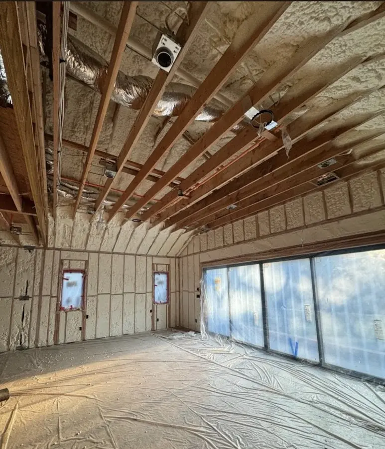 Interior walls and ceiling insulated with spray foam during new construction in Clinton